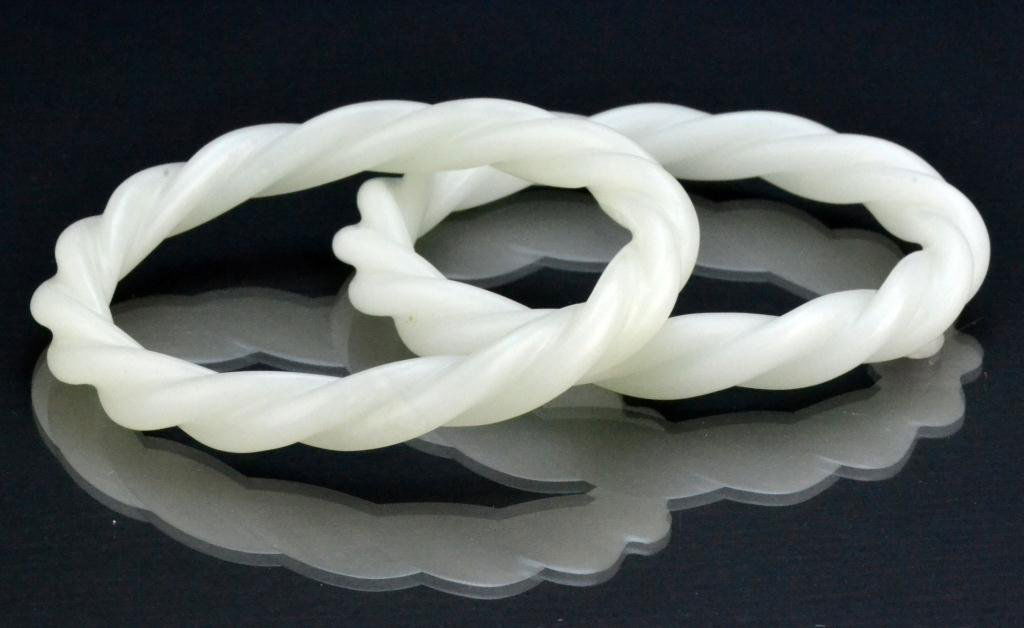 Pr. Chinese Qing White Jade Bangle Bracelets: Finely carved a twisted rope, the stone an even white tone with very fine polish, outside diameter 3", inside diameter 2.5", circa late 19th/early 20th century. Property of a Houston Texas Gentleman