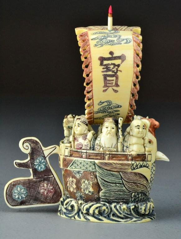 Japanese Polychromed Painted Ivory Of Seven Lucky: Finely carved to depict the Seven Lucky Gods of Japan in their ship The Takarabune, with removable ivory rudder and sail , ship carved as a rooster with lotus blossom design, the bottom further decora