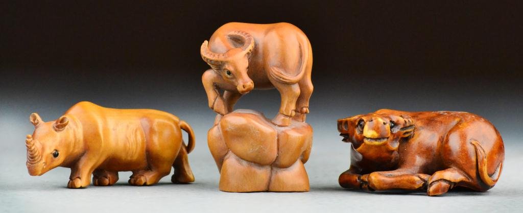 (3) Japanese Meji Period Hardwood Netsuke: To include two carved to depict buffalo, together with one carved to depict rhinoceros, all three bearing two character mark, tallest is 2"H. Property of a Holly MI Gentleman.