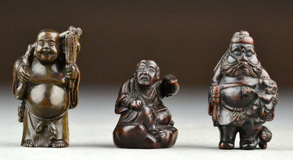 (3) Japanese Meji Period Carved Wood Netsuke: Each finely carved to depict a different elder, each holding precious objects, all signed, height of tallest 2.21875"H. Property of a Holly MI Gentleman.