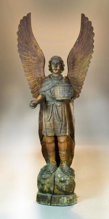 Antique Life-size Carved Wood Statue of Angel: Depicting large finely carved wooden angel standing on a rock holding a basket in one hand and a loaf of bread in the other, detachable wings, 80" H x 33" W x 18" D, circa 20th century. Condition: spl