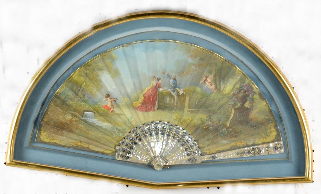 Hand-painted MOP Fan in Shadow Box: Depicting a waterfall scene with putti and Period French figures with fruit, signed with initials MP on LR, finely reticulated mother-of-pearl staves with floral gilt decoration, beautifully framed in