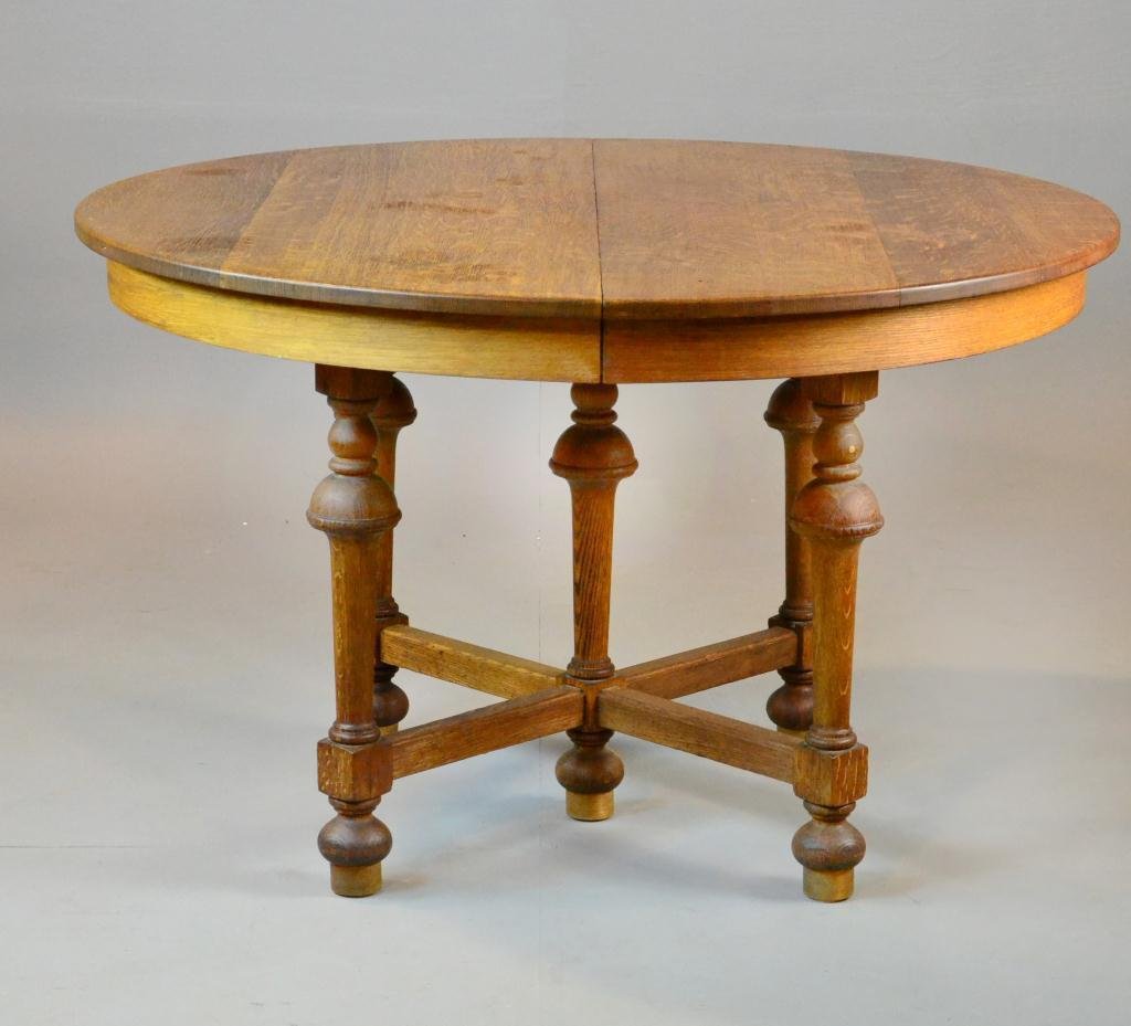 Stickley Brothers Oak Dinning Table: With circular top; having vasiform turned uprights joined by x-form block stretchers; with two additional leaves. Having original paper label and additional impressed stamp for Stickley Bros. Grand Ra