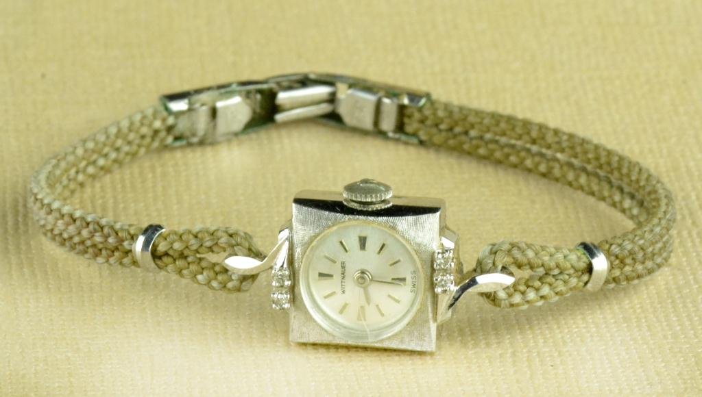 Antique Ladies 14K Gold/Diamonds Witnauer Watch: An art Deco ladies wrist watch having a square face and circular dial, the top and bottom mounted with two small diamonds each, the case stamped 14k, 7.4 grams total weight, 6.5" L, circa early 20th c
