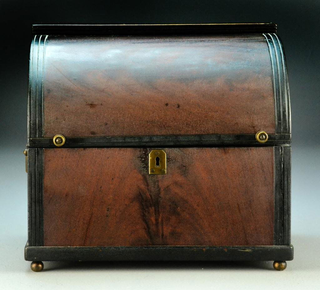 An American Mahogany Letter Box: In the form of a roll top desk, the lift top opening to reveal a sectioned interior, retaining its original lock and key escutcheon and raised on four bun feet, 10.25" H x 12" W, circa late 19th-early