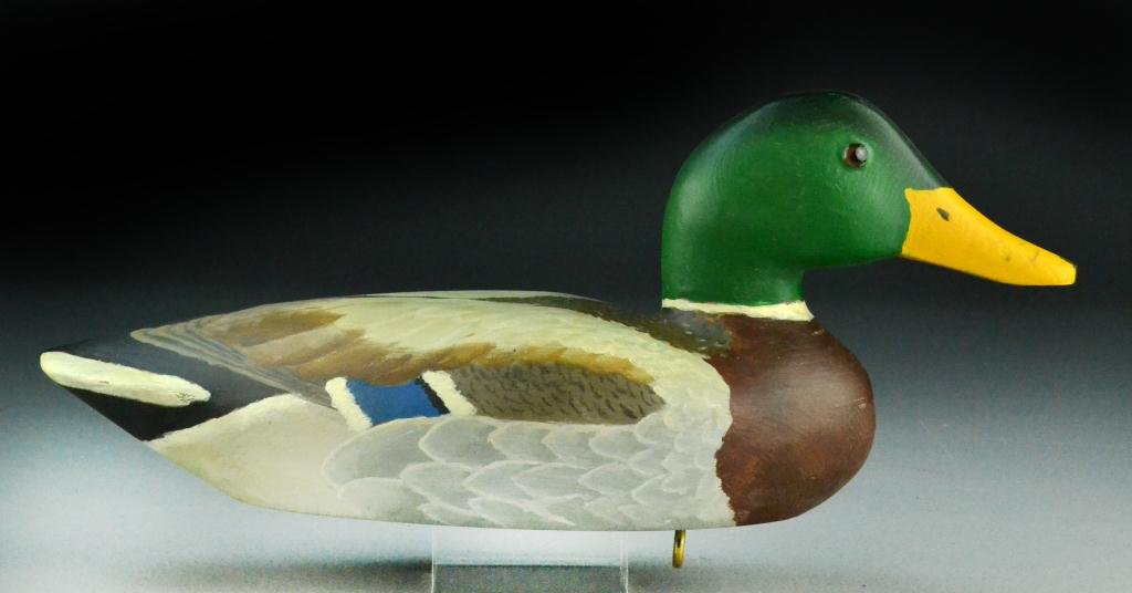 John Polk Mallard Drake Duck Decoy: Polychrome painted with glass eyes, weight on bottom with screw eye, marked John Polk, Pr 30, signed under bill, 16.5" L, circa 1980. Condition: good. Provenance: From The Estate of The Late James W. 