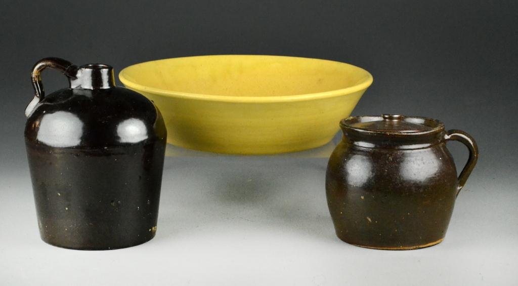 (3) Pieces Early American Pottery: To include a yelloware milk bowl, 12" diameter, a handled jug and a covered bean pot, all circa 19th century. Property of an Oxford, Michigan Gentleman.