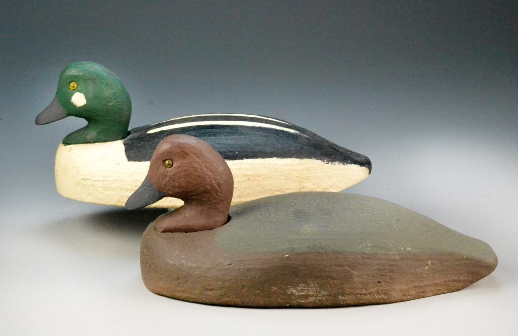 (2) Herter's Goldeneye Duck Decoy: Both with yellow glass eyes and working repaint, by Herter's Decoy Company, Minnesota , circa 1940's, largest 14" L, minor nick to side of one decoy.