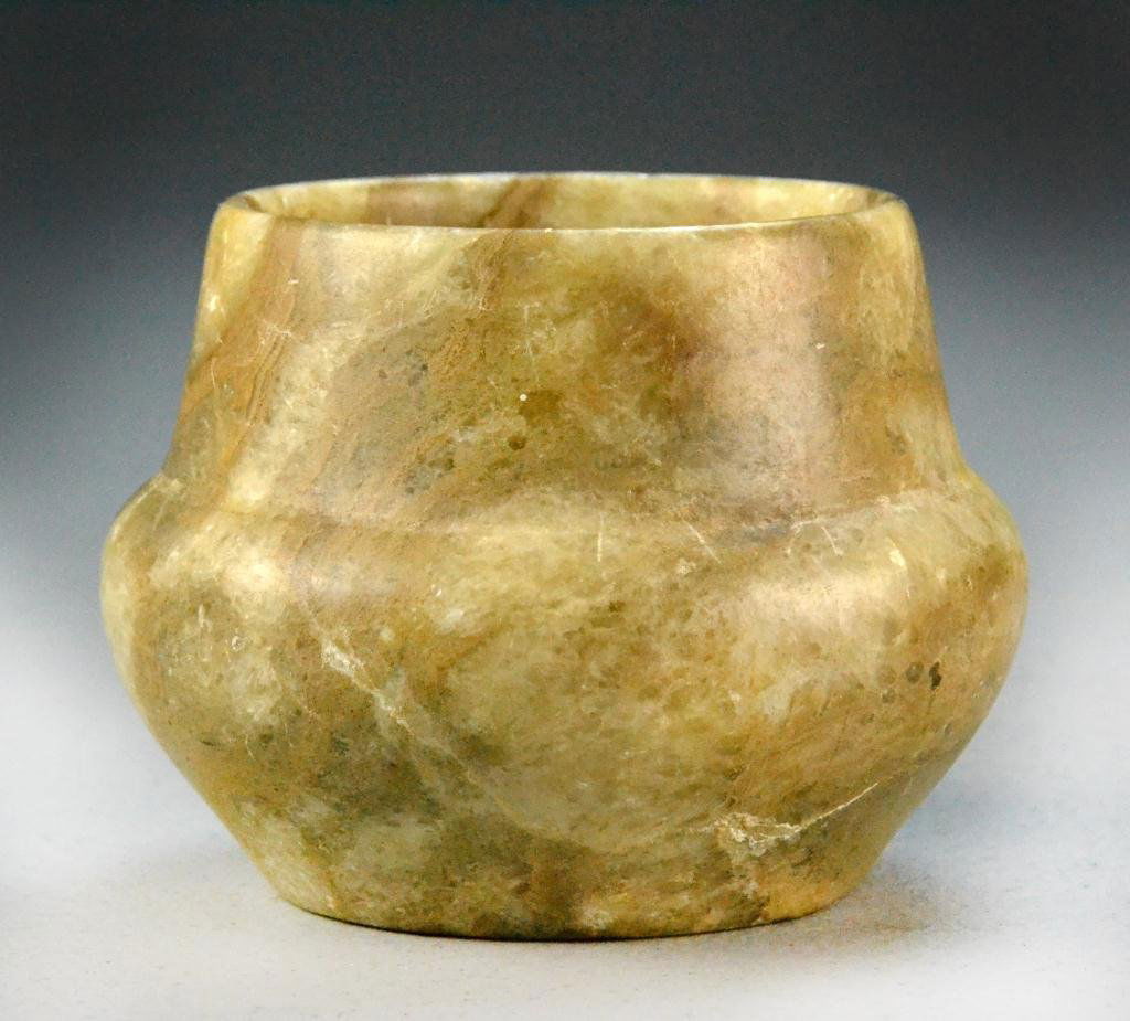 Carved Alabaster Vessel Possibly Roman or Egyptian: Bulbous with curving shoulders, probably carved on a wheel, striated white to brown, 3.75" H x 4.25" Diameter, age unknown. Condition: very good. Property of Holly, Michigan, gentleman.