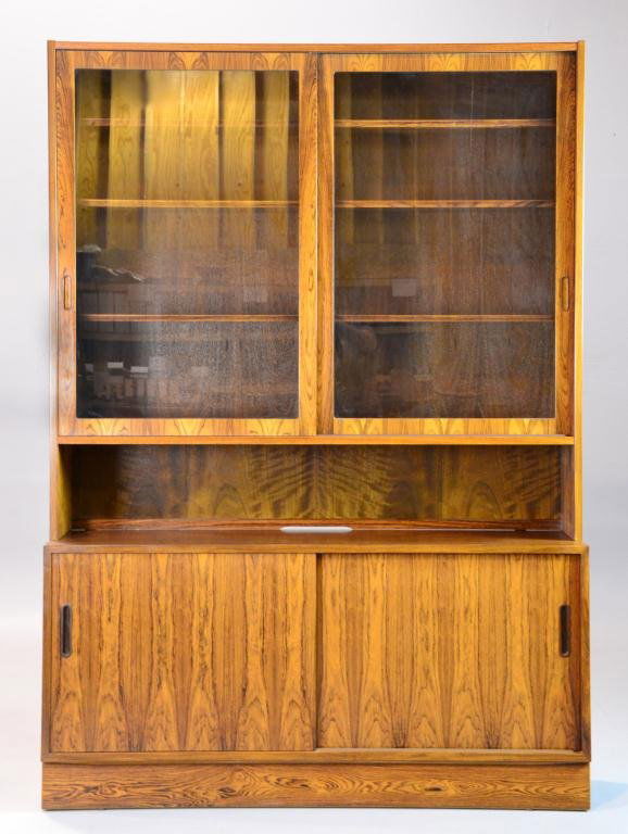 Mid Century Hundevad Danish Teak Cabinet: Consisting of a rosewood teak cabinet with two sliding glass doors, divided in the center with three shelves on each side (50.75" H x 54.5" W x 12" D) along with a matching credenza having two sliding