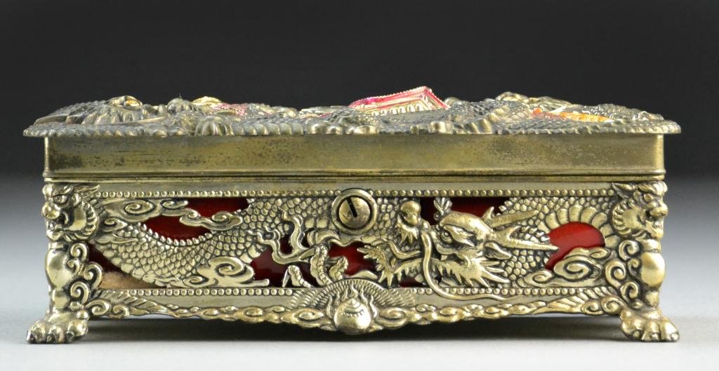 Japanese Polychrome Painted Silvered Box: Finely molded to depict two dragons surrounding a buhdda seated in front of a palace, with silk lining, original lock lacking key and molded dragon mark to base. 7"W x 4"D x 2.5"H, circa early to mid 