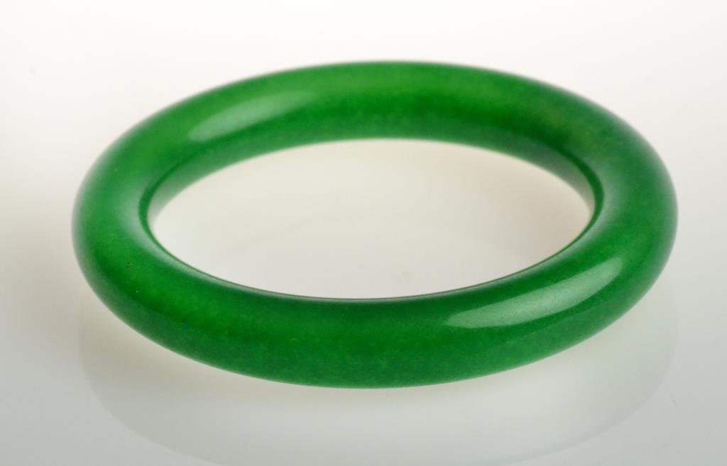 Chinese Apple Green Jade Bangle Bracelet: A dark apple green color graduating to light green well carved with fine polish, outside diameter 3.25", inside diameter 2.5", circa late 19th/early 20th century. West Bloomfield Michigan Collection.