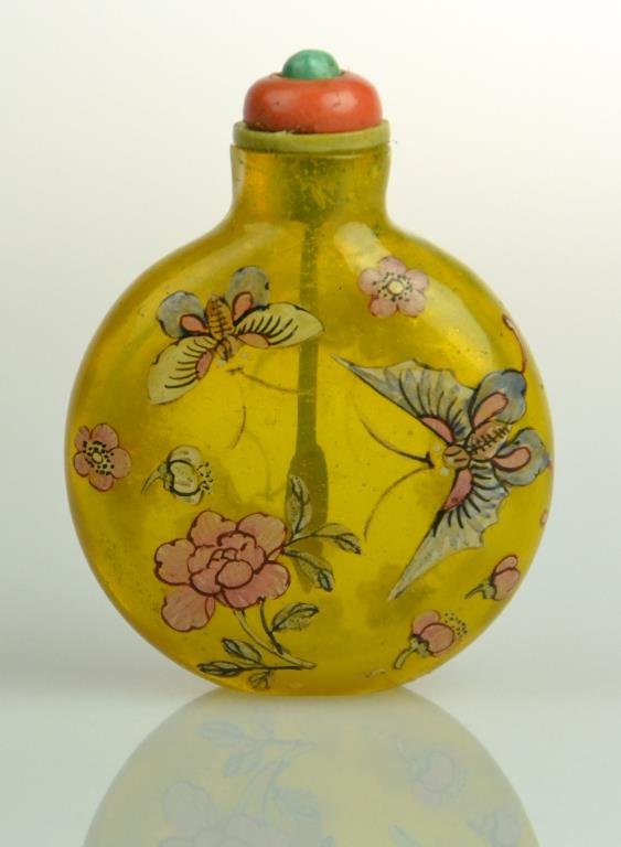Chinese Qing Chicken Fat Yellow Glass Snuff Bottle: Finely painted to depict butterflies and flowers, having coral, turquoise, and jade stopper with bone spoon, 2.75"H, circa 19th century. Property of a Royal Oak Michigan Lady.