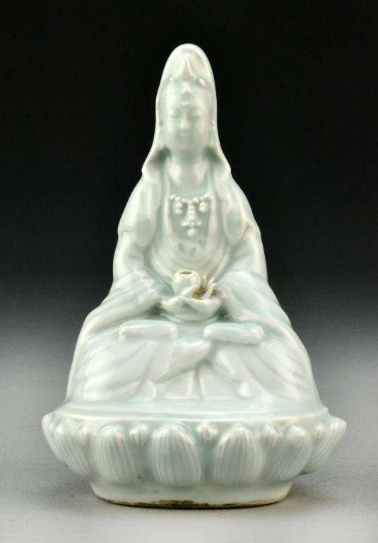 Chinese Longquan Porcelain Figure: Finely molded as a seated Guanyin resting on a lotus throne, she is dressed in long flowing robes, base with indistinguishable stamp, 6.75"H.
