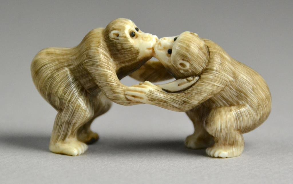 Japanese Carved Ivory Netsuke: Finely carved as two kissing monkeys with inlaid glass eyes, well carved, with a two character mark within a square to left buttocks of one monkey, 1.25"H X 2.25"L, circa 20th century or earlier. Prop