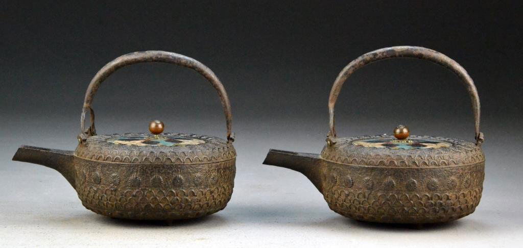 Pr. Japanese Antique Iron Tea Pots: Depicting chrysanthemum blossoms, having two cloisonné lids, 6"H X 7"L 5.25"D, circa 18th-19th century. Property of a Houston Texas Gentleman.