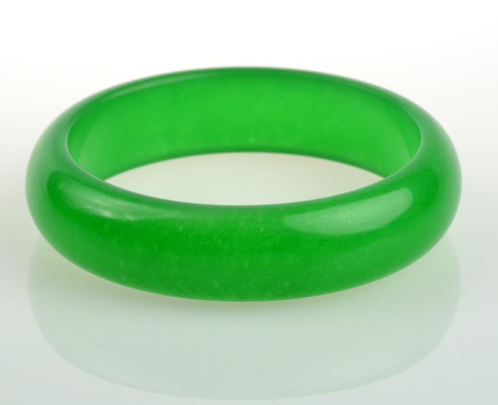 Chinese Apple Green Jade Bangle Bracelet: A nearly translucent apple green color with fine carving and polish, outside diameter 3", inside diameter 2.5". West Bloomfield Michigan Collection.