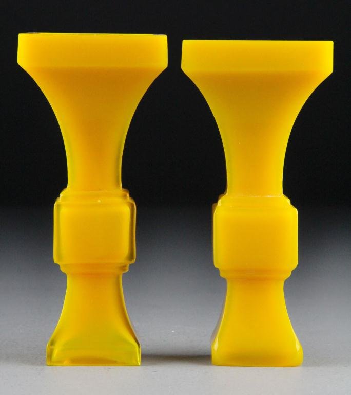 Pr. Chinese Chicken Fat Peking Glass Vases: Molded after archaic bronzes, the glass a rich chicken fat color, each with carved seal mark to foot rim, 6.5"H. Condition: One foot with polished down corners probably from chipping otherwise excelle