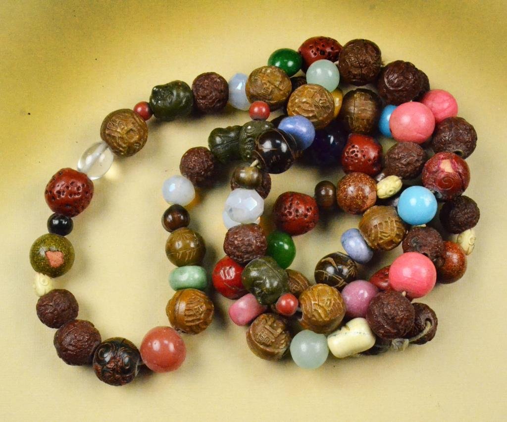Chinese Qing Beaded Necklace: Consisting of ninety-two circular beads carved from nuts, cinnabar, semi-precious stones, and various other materials, measures approximately 54"L, circa late 19th/early 20th century. Private collecti