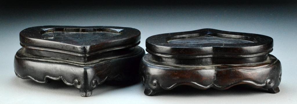 Pr. Chinese Qing Peach Form Rosewood Stands: Two finely carved heavy rosewood stands in the form of peaches, having tripod ruyi feet, 3.25"H X 8.75"W, circa late 19th/early 20th century. Provenance: property of a Flint MI lady.