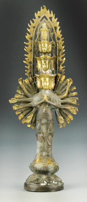 Chinese Bronze Figural Group: Finely molded as a Buddhist deity with many arms and several faces standing atop a lotus plinth, 13.25"H. Property of a Traverse City Michigan Gentleman.