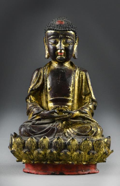 Chinese Ming Bronze Buddha Statue: Finely cast as a Buddha seated on a double lotus throne, his hands in Buddhist mudra with a swastika on his chest, 9"H X 6.5"W, circa Ming Dynasty. Condition: Parts of the bronze have been painted red