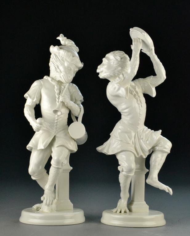 Pair Mottahedeh Blanc de Chine Dancing Monkeys: Depicting one white porcelain monkey dancing and playing a flute and one playing the tambourine, made to resemble Meissen white porcelain animal figures, with underglaze purple Mottahedeh mark to bott