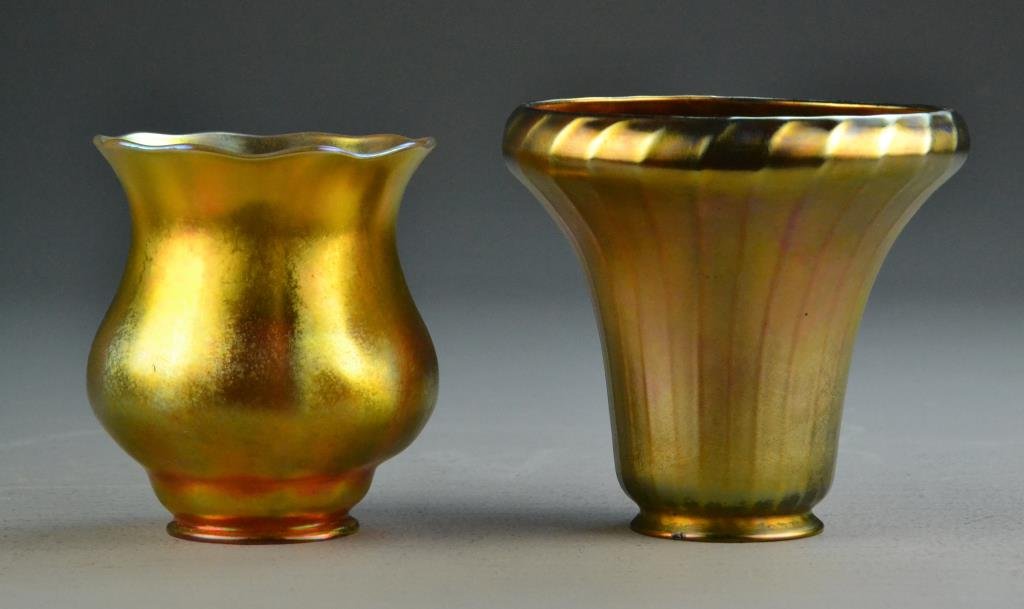 (2) Favrille Iridescent Lamp Shades: To include one upright tulip shade and one ribbed bell-shaped shade, 5" h each, circa early 20th century. Condition: One with chip to rim. Property of Adrian, Michigan, gentleman.