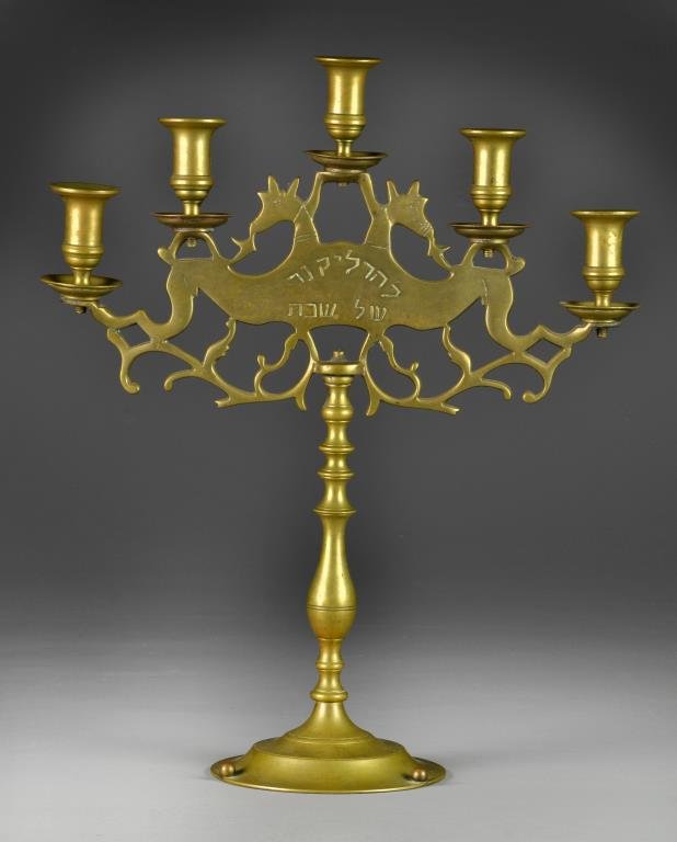 Antique European Brass Judaica Menorah-Candelabra: Candelabra with five stepped lights raised on scrolled figures of animals, with Hebrew writing to both sides, vasiform column on graduated base, 18"H, circa late 19th-early 20th century. Condition: Go