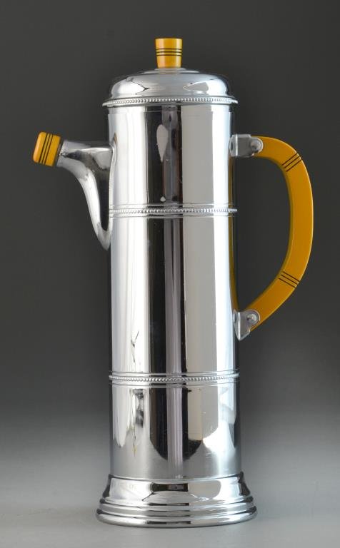 An Art Deco Chrome & Bakelite Skyscaper Pitcher: Having a bakelite handle, spout cover, and finial and chrome body, 12.5"H, circa 1920's. Condition: Mint. Provenance: Formally in the collection of Gary Culpepper of Culpepper Galleries-Santa Fe, New 