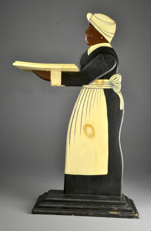 An American Carved & Painted Wood Dumb Waiter: Depicting a mammie on stepped base, appears to retain its original vibrant paint decoration, circa 1920's to 1940's, 37"H. Private collection Dearborn, Michigan.