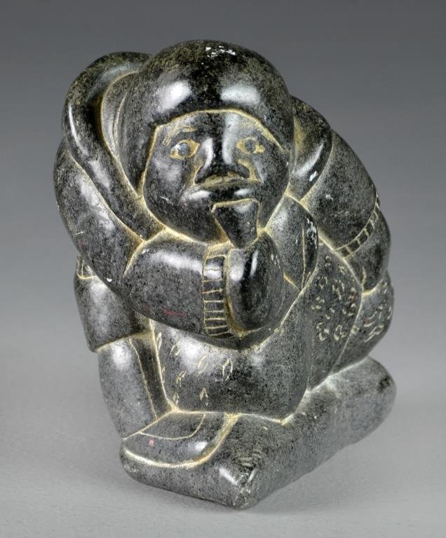 Carved Soapstone Inuit Sculpture: Depicting a young Eskimo with backpack, initialed J.H., with several additional numbers, 5.5"H X 7"W, circa mid-20th century. Private collection Dearborn, Michigan.