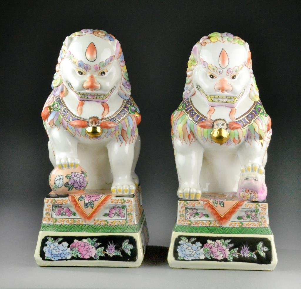 Pair of Chinese Porcelain Foo Dogs: Polychrome painted and gilt matching Foo Dogs, one has right foot on a floral ball and the other with left foot on a baby, 14" H, circa 20th century. Condition: good. The Trust of Ethel Siegel, W. Blo
