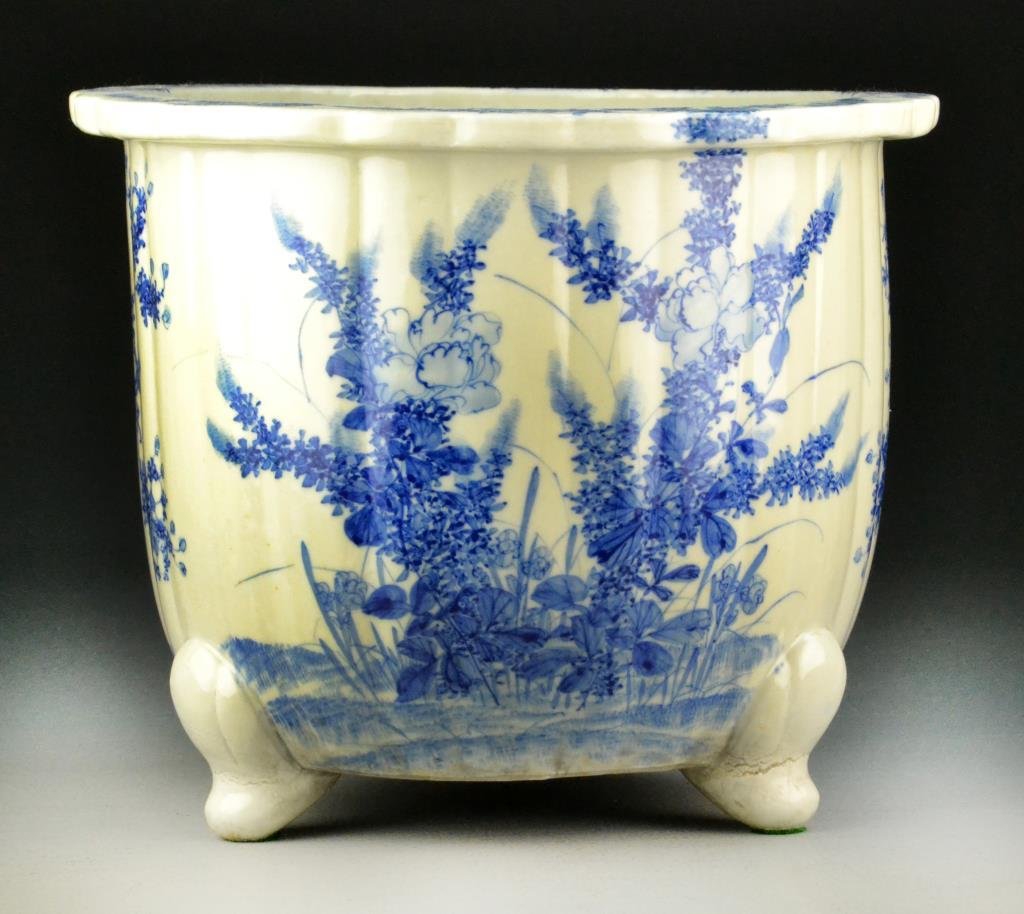 Japanese Aritaware Blue & White Porcelain Flower Pot: Floral decoration on pot and rim, raised on three short feet, 10.5" H x 12.5" Diameter. Condition: good. Property of an Metamora, Michigan, lady and gentleman.