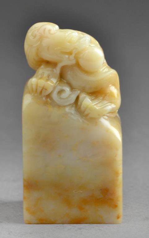 Chinese Soapstone Seal Chop: Carved to depict a dragon holding a pearl amongst ruyi clouds atop a plinth, the seal face uncarved, 2.25"H. West Bloomfield Michigan Collection.