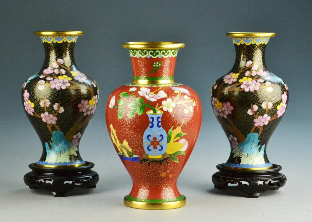 (3) Chinese Cloisonne Vases and Stands: Red cloisonne floral 8" vase and two black 7" cherry blossom & bluebird cloisonne vases along with with 2 stands, circa 20th century. Condition: good. Property of Fenton, Michigan, lady.