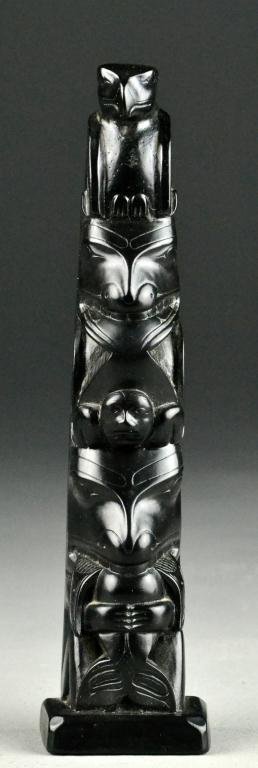 A Native American Composition Totem Pole: Finely carved and polished to depict eagles and figures, signed "Tahnoo" made in Canada, circa mid-20th century.