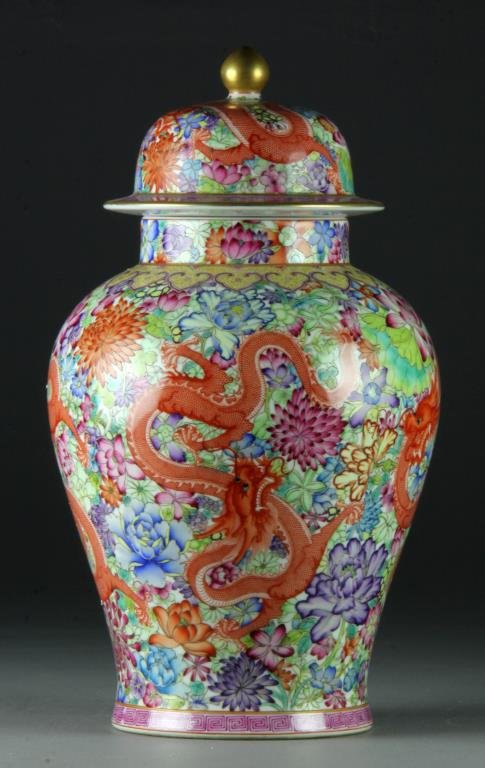 Chinese Mille Fleur Porcelain Covered Urn: Finely painted to depict iron red dragons amongst many flowers, the base bearing Qianlong seal mark in underglaze blue, the lid with gilt finial, 17.5"H. Private collection of a gentleman.