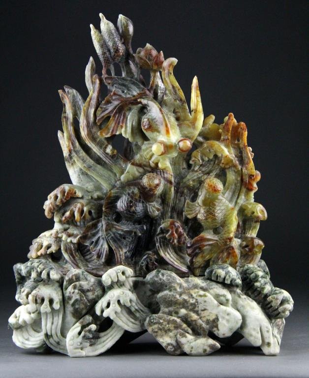 Chinese Jade Carving of Popeyed Goldfish and Waves: Finely carved jade of various colors depicting large popeyed goldfish and marine plants raised on carved base depicting waves, 14" H x 12" L including base, circa 20th century, good condition.