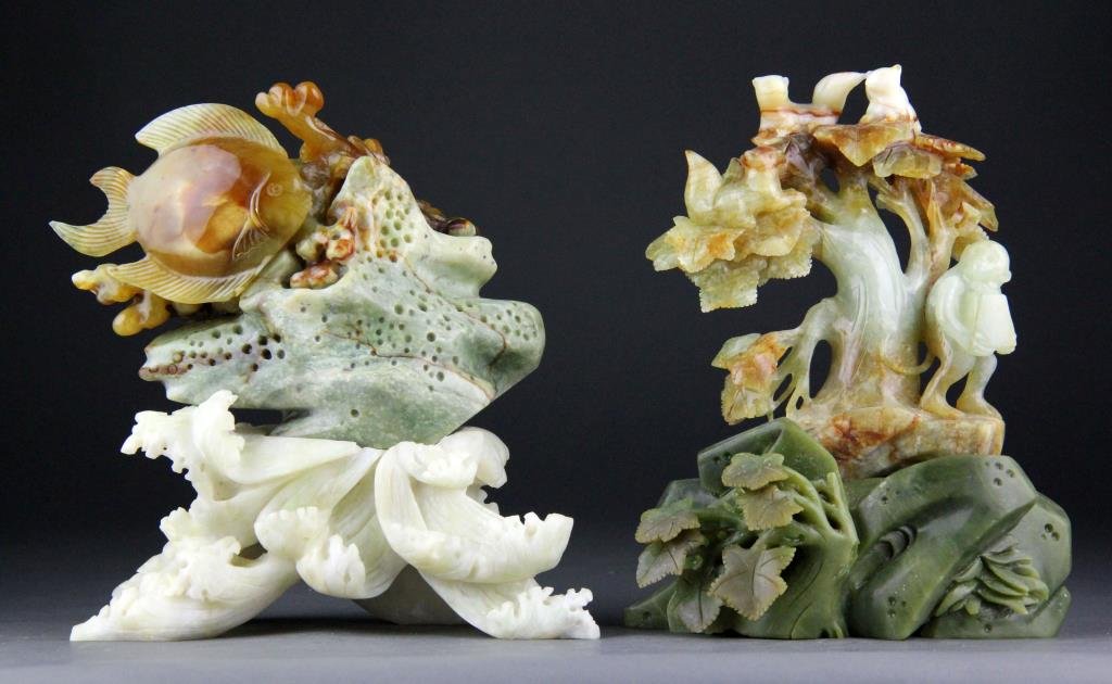 (2) Chinese Jade Carvings of Animals and Fish: To include a finely carved celadon and rust colored jade of monkey and squirrels in tree on green jade base with leaves along with a jade carving of fish and clam on white jade base depicting waves, l