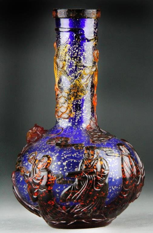 Chinese Peking Glass Vase - Amber/Red/Cobalt: Narrow-necked vase with bulbous body having amber and red overlay over cobalt blue ground with gold flecks, Greek Key design on rim, body carved with large red dragon and several male figures: one app