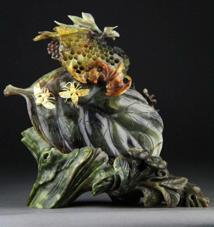 Chinese Jade Carving of Bees, Honeycomb and Leaf: Finely carved medium to dark jade depicting honeycomb with bees along with batts and large leaf raised on dark green carved jade floral base, 8.75" H x 10" L including base, circa 20th century, good c