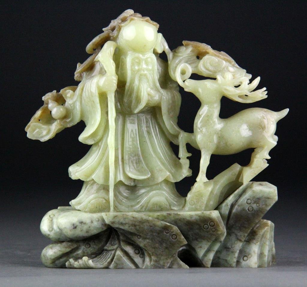 Chinese Jade Carving of Elder and Deer: Finely carved light green jade depicting elder & bats with staff and dear raised on carved jade base, 6.75" H x 6.5" L including base, circa 20th century, good condition.