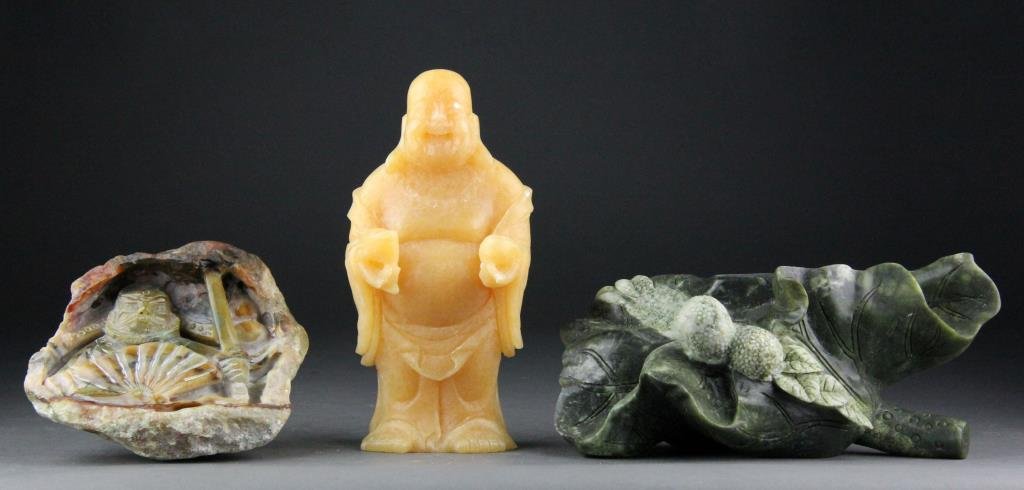 (3) Chinese Jade Carvings of Lychee, Elder & Buddha: Finely carved jades one depicting lychee with lotus pad, one warrior carved from small jade boulder and one of laughing Buddha, largest is 9" H x 4" L, circa 20th century, buddha has a few nicks lot i