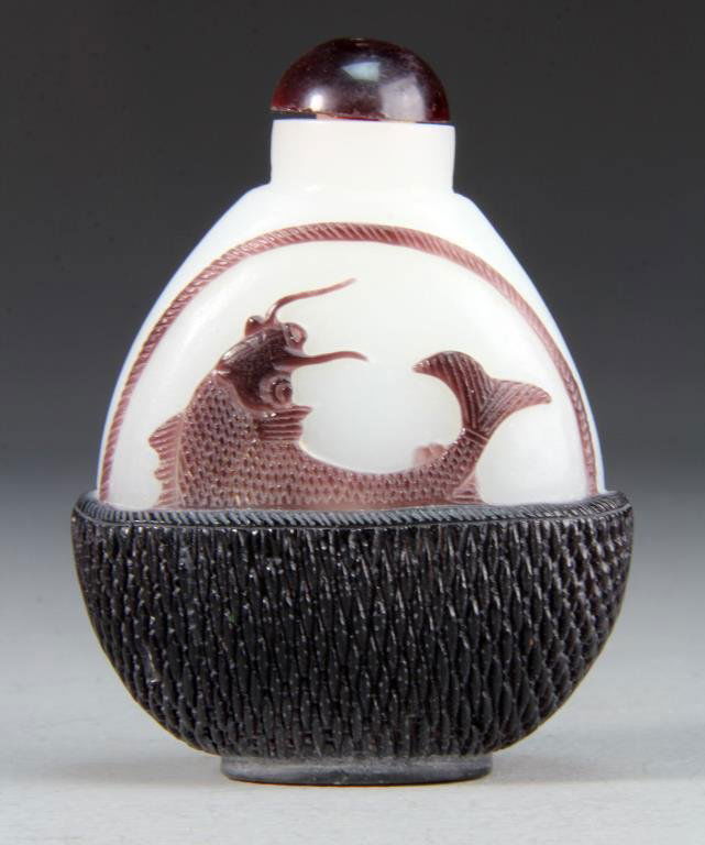 A Fine Chinese Peking Glass Snuff Bottle: A large snuff bottle finely formed as a basket carrying coi fish, measures 4.25"H