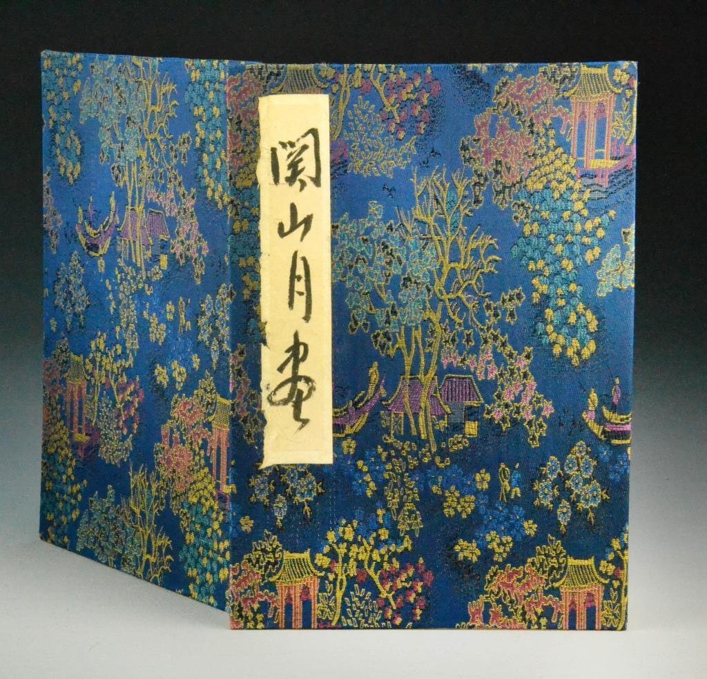 Chinese Album of Eight Ink Paintings Manner of Guan Sha: Chinese Album of Eight Ink Paintings Manner of Guan Shanyue. Twenty-four pages of landscape and seascape ink painting in accordian-bound brocade book, 11" H x 8" W unopened. Condition: foxing to corne