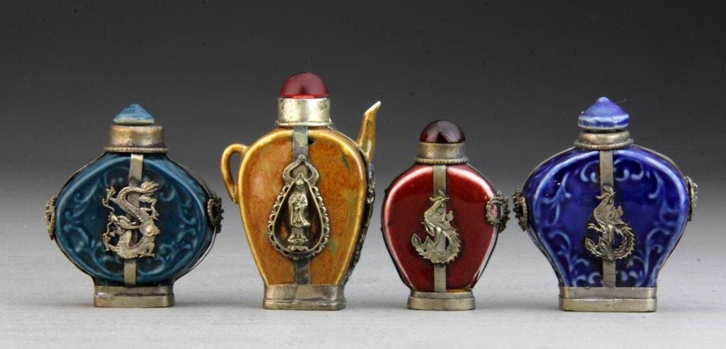 (4) PcsChinese Porcelain Snuff Bottles W. Metal Casing: Detailed casings of dragon, phoenix and Guanyin atop lotus flower, one in shape of tea kettle, bases bear 1, 2 and 4 character marks, tallest is 3.25"H. Condition: one casing detached.