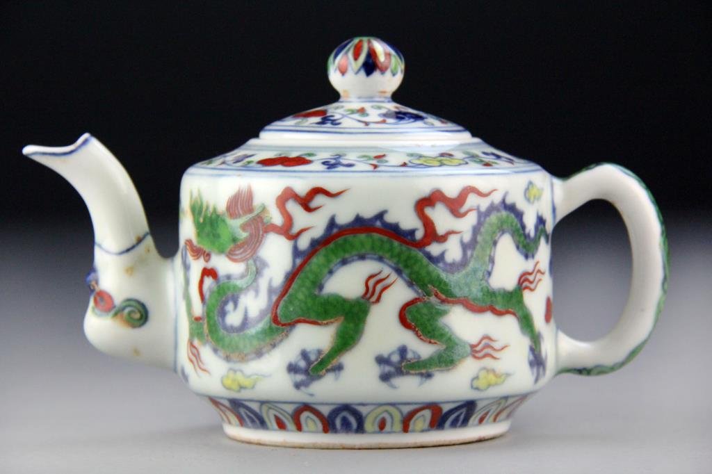 Chinese Wu Cai Porcelain Teapot: Small five-color teapot with dragon decoration, floral/tendril decoration on lid, shoulder, spout and handle, underglaze blue six character marks on bottom, 4" H x 6.5" W,circa 20th century, good cond