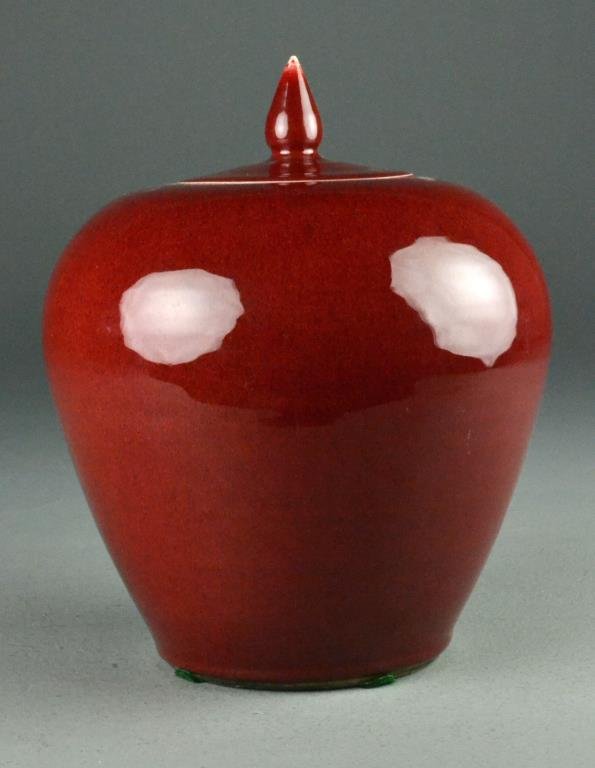 Chinese Sang de Boeuf Porcelain Covered Urn: Having beautiful deep ox blood glaze, the lid with acorn finial, base having four old felt pads attached. 10.5"H, circa late 19th/early 20th century.