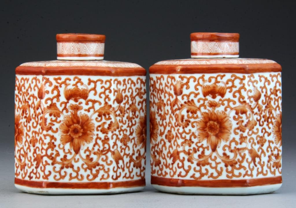 Pr. Chinese Iron Red and White Porcelain Jars: Finely painted with scrolling tendrils and geometric band at top and around cap, 5.75"H x 4.75"W.
